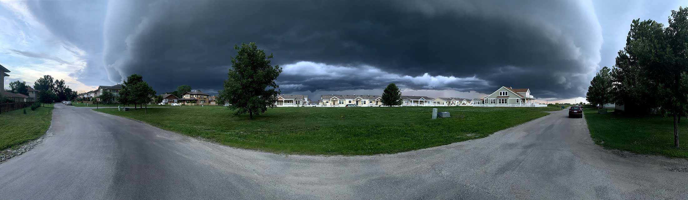 Wide angle photo of neighborhood with a cloudy sky